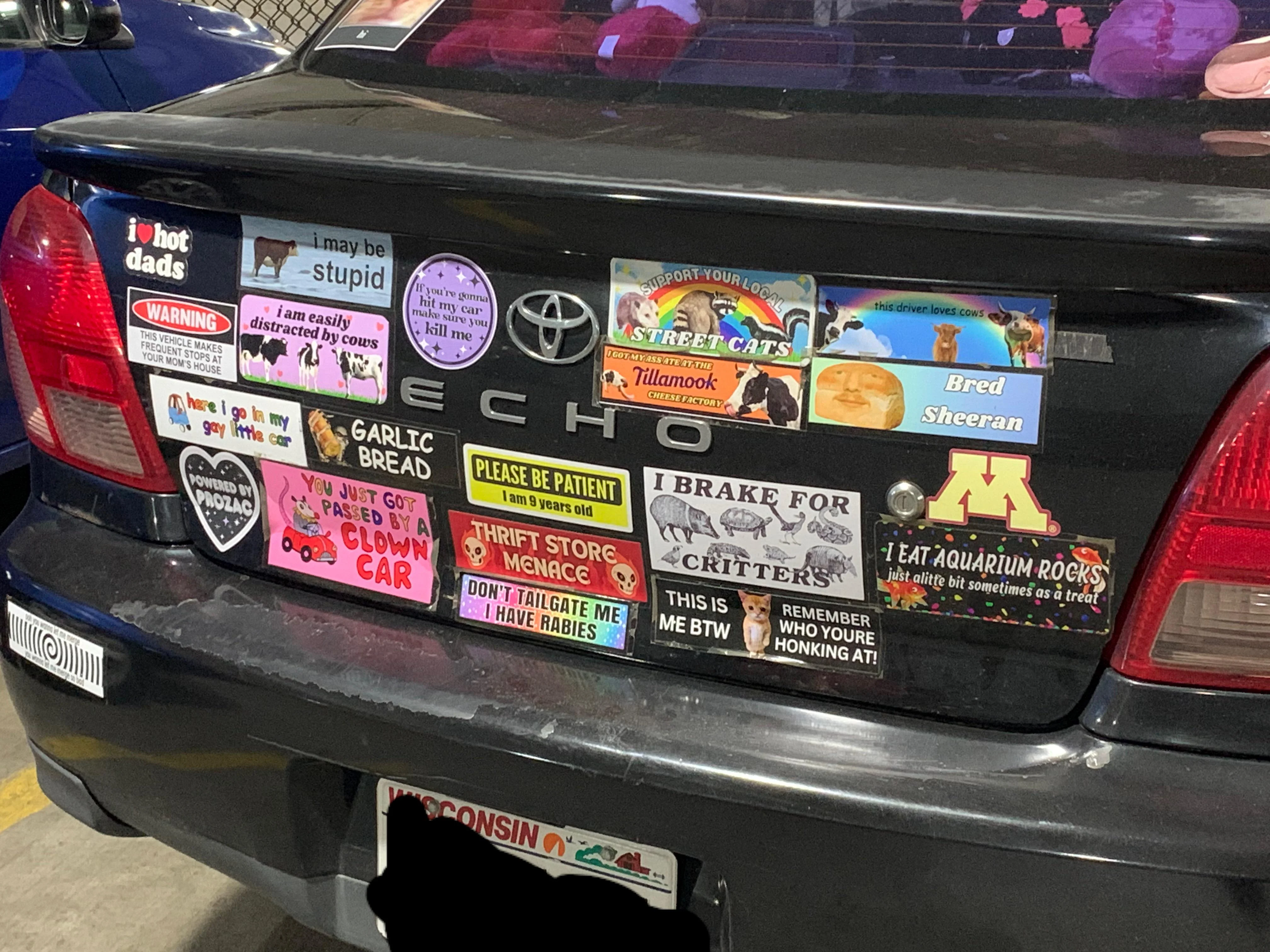 A car bumper completely covered in stickers